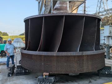 Jay Tiley inspects a hydroelectric runner from TVA’s Cherokee Dam