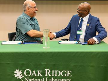 Moe Khaleel, left, associate laboratory director for national security sciences, and Maurice Singleton, chief executive officer of U2opia Technology, celebrate the partnership between Oak Ridge National Laboratory and U2opia Technology. Credit: Carlos Jones/ORNL, U.S. Dept. of Energy