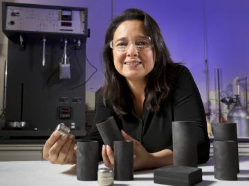 For NASA’s Mars 2020 rover mission, Nidia Gallego produces components of carbon-bonded carbon fiber (CBCF, in gray) for insulating an iridium-clad plutonium heat source power supply (inert prototype shown in silver).
