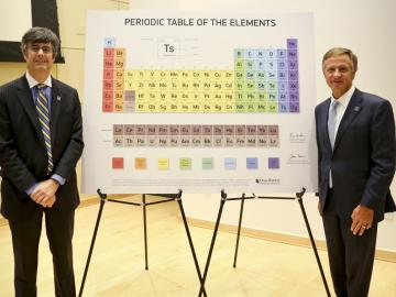 ORNL Director Thom Mason, left, and Tennessee Gov. Bill Haslam stand beside the updated periodic table including tennessine, Ts, located on the next to last row from the bottom and third from the right. (ORNL photo by Jason Richards) 