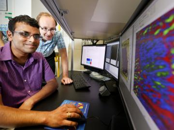 ORNL’s Sergei Kalinin and Rama Vasudevan (far left) used scanning probe microscopy to discover inseparable interplay between bulk ferroelectricity and surface electrochemistry in a 30-nanometer-thick film of barium titanate.