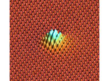 Neon atoms between graphene sheets poke the top sheet from below and stretch the crystalline lattice, forming a bubble at a pressure larger than that of the ocean at its greatest depth. Neon atoms between graphene sheets poke the top sheet from below and stretch the crystalline lattice, forming a bubble at a pressure larger than that of the ocean at its greatest depth.