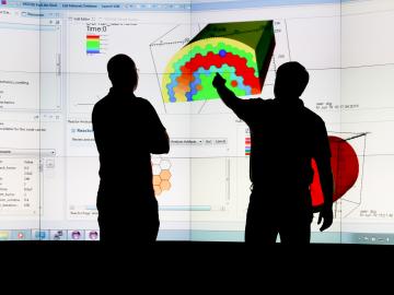 Jay Jay Billings and Alex McCaskey observe visualizations of ICE simulation data on ORNL’s Exploratory Visualization Environment for Research in Science and Technology facility. Credit: Jason Richards/ORNL Jay Jay Billings and Alex McCaskey observe visualizations of ICE simulation data on ORNL’s Exploratory Visualization Environment for Research in Science and Technology facility. Credit: Jason Richards/ORNL
