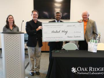 Former University of Tennessee football coach Phillip Fulmer (right) helps ORNL celebrate $858,000 of contributions to this year’s United Way campaign.