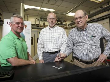 From left, ORNL’s Rick Lowden, Chris Bryan and Jim Kiggans were troubled that target discs of a material needed to produce Mo-99 using an accelerator could deform after irradiation and get stuck in their holder.