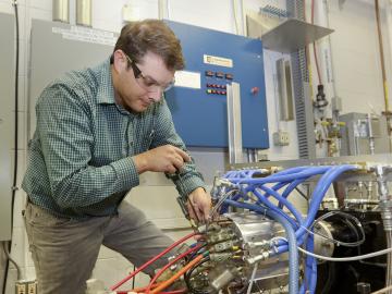 Oak Ridge National Laboratory researcher Tim Burress works with a prototype motor that generates 75 percent more power than comparable commercial motors without the use of rare earth materials. Oak Ridge National Laboratory researcher Tim Burress works with a prototype motor that generates 75 percent more power than comparable commercial motors without the use of rare earth materials.