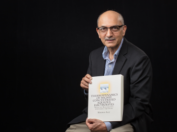 ORNL researcher Moonis Ally with his published theory: "Thermodynamics of Highly Concentratied Aqueous Electrolytes." ORNL researcher Moonis Ally with his published theory: "Thermodynamics of Highly Concentratied Aqueous Electrolytes."