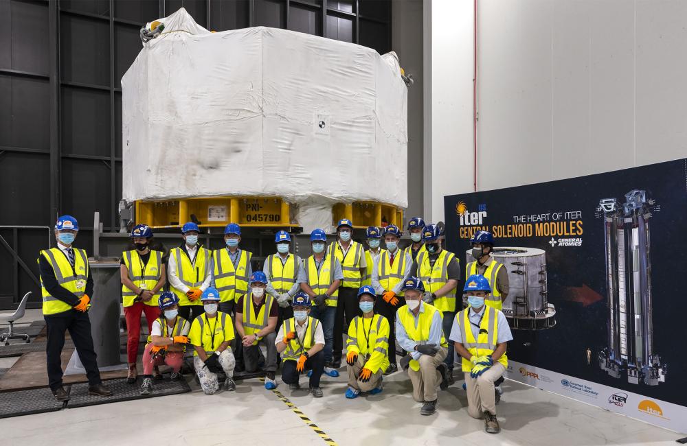 ITER staff in front of first central solenoid.