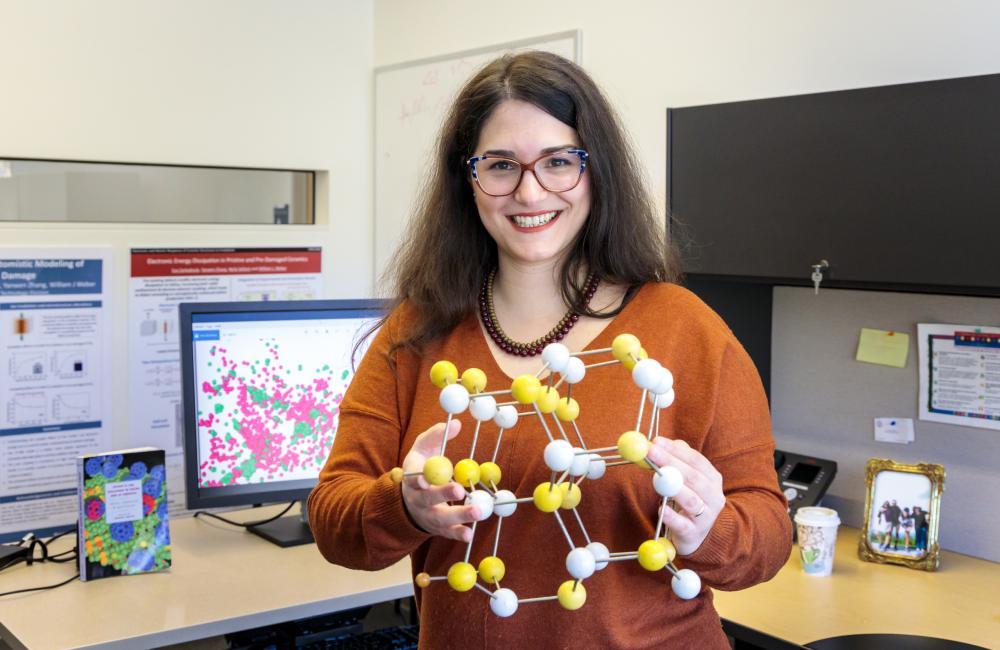 ORNL’s Eva Zarkadoula seeks piezoelectric materials for sensors that can withstand irradiation, which causes cascading collisions that displace atoms and produces defects. Credit: Carlos Jones/ORNL, U.S. Dept. of Energy 