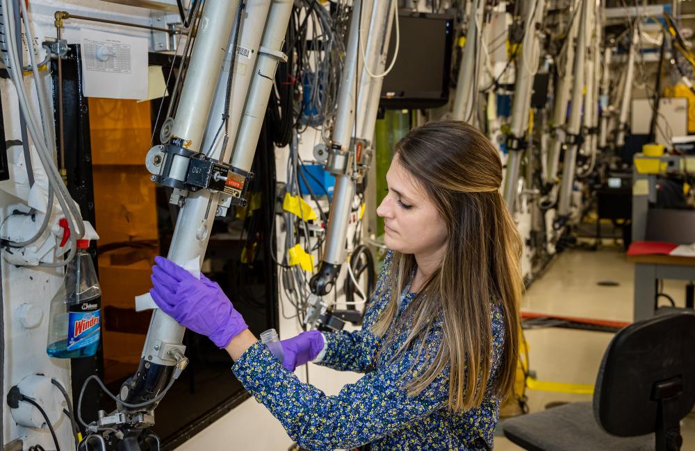 Brittany Herman collecting metals sample on manipulator arm