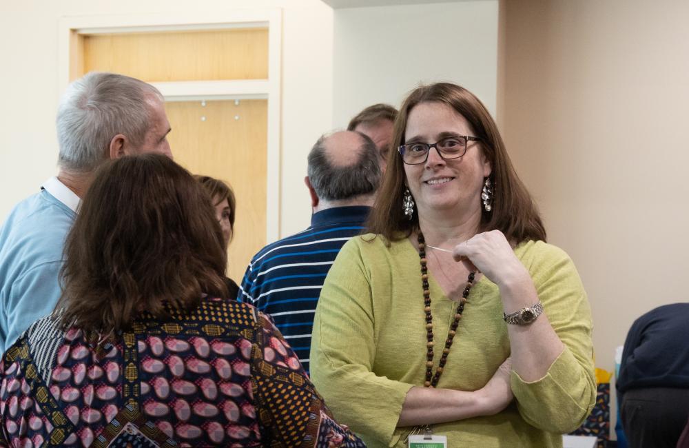 Photograph of Jennifer Shell talking with colleagues at an ORNL function