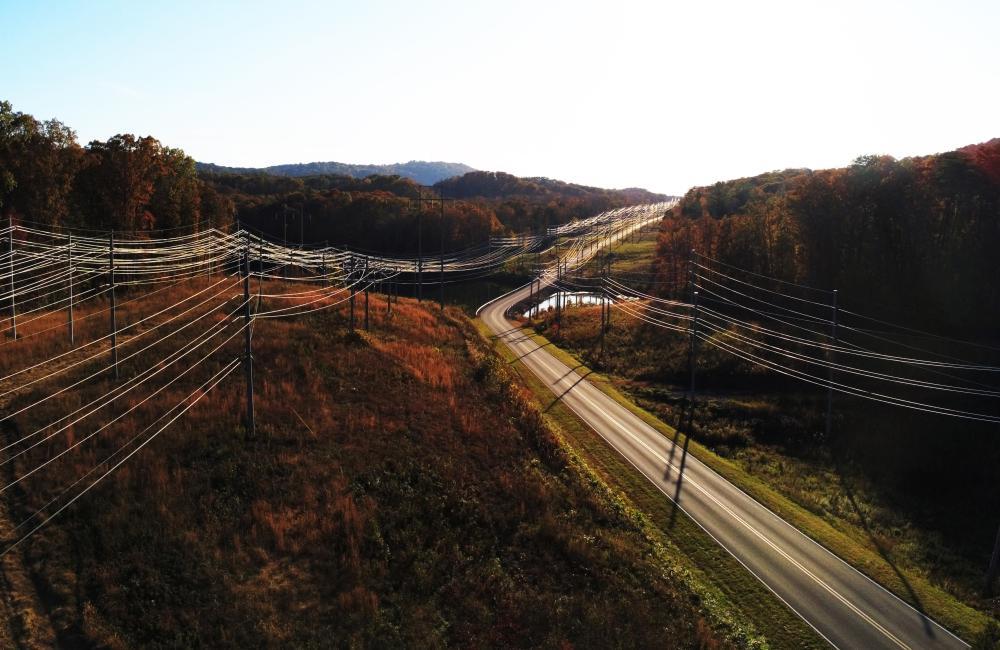 power lines running next to a mountain road in Autumn