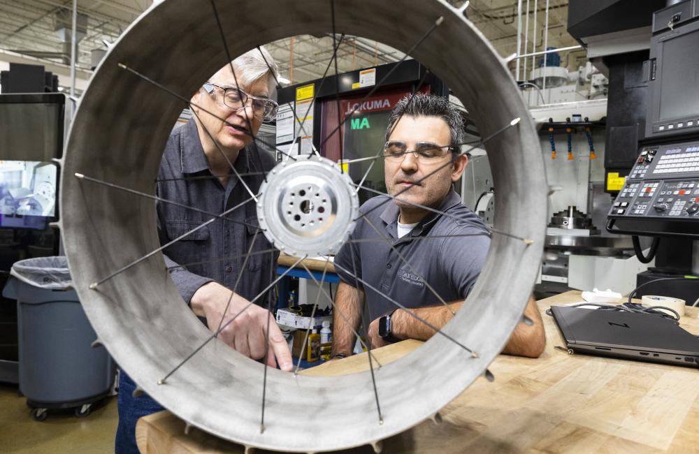 NASA mechanical design engineer Richard Hagen, left, and ORNL researcher Michael Borish inspect a lunar rover wheel prototype that was 3D printed at the Manufacturing Demonstration Facility