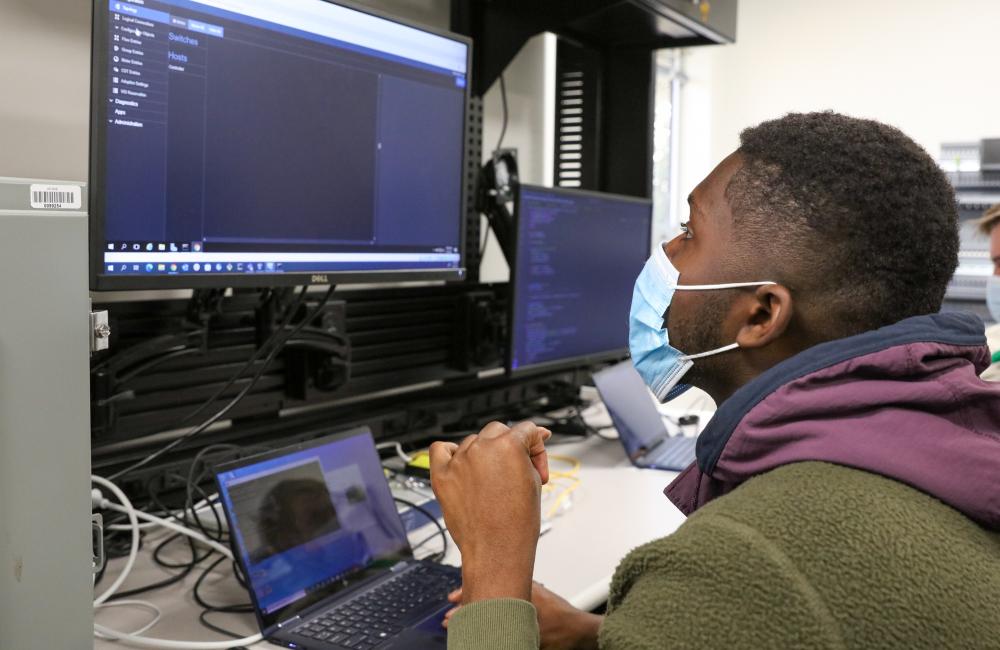 A researcher looks a a computer screen in a cyber lab