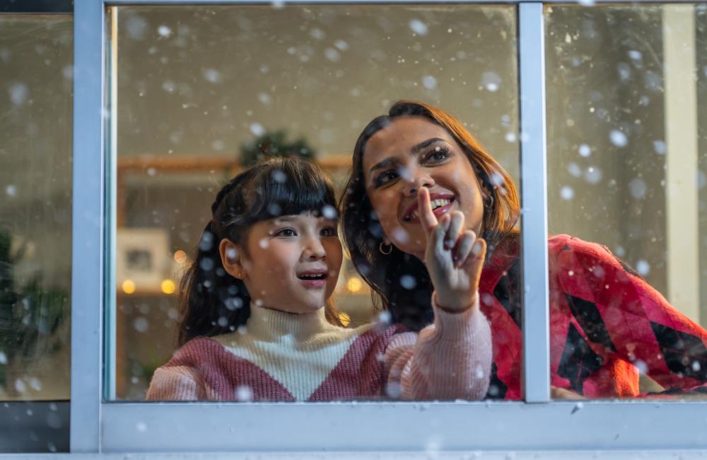 Child by window while snowing (Envato Elements)