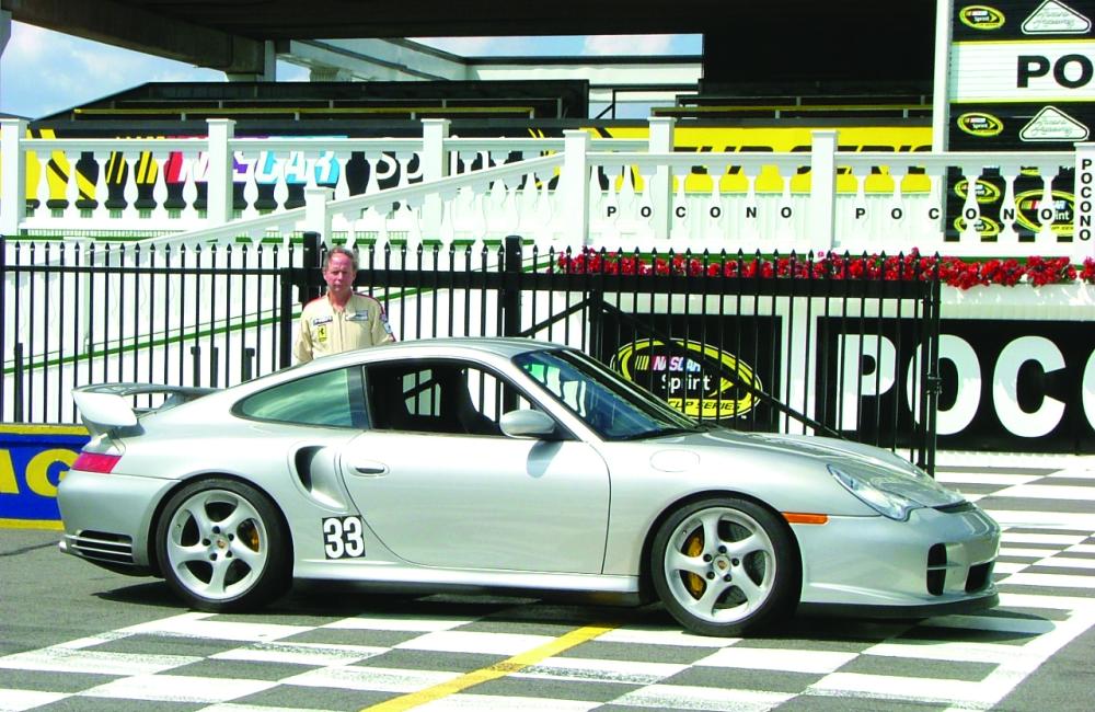 Ron Graves with his current track car, a rare Porsche 911 GT2, at the victory circle area of Poconoe Raceway in Pennsylvania.