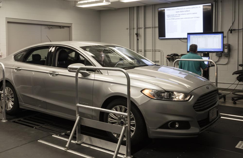 ORNL’s Frank Combs and Michael Starr of the U.S. Armed Forces (driver) work in ORNL’s Vehicle Security Laboratory to evaluate a prototype device that can detect network intrusions in all modern vehicles. Credit: Carlos Jones/ORNL, U.S. Dept. of Energy