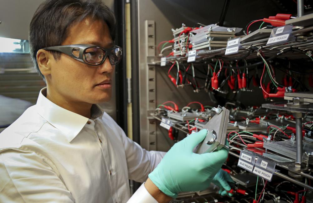 ORNL researcher and University of Tennessee Bredesen Center for Interdisciplinary Research and Graduate Education student Seong Jin An works with lithium-ion batteries undergoing an ORNL-developed fast-formation protocol that shortens part of battery