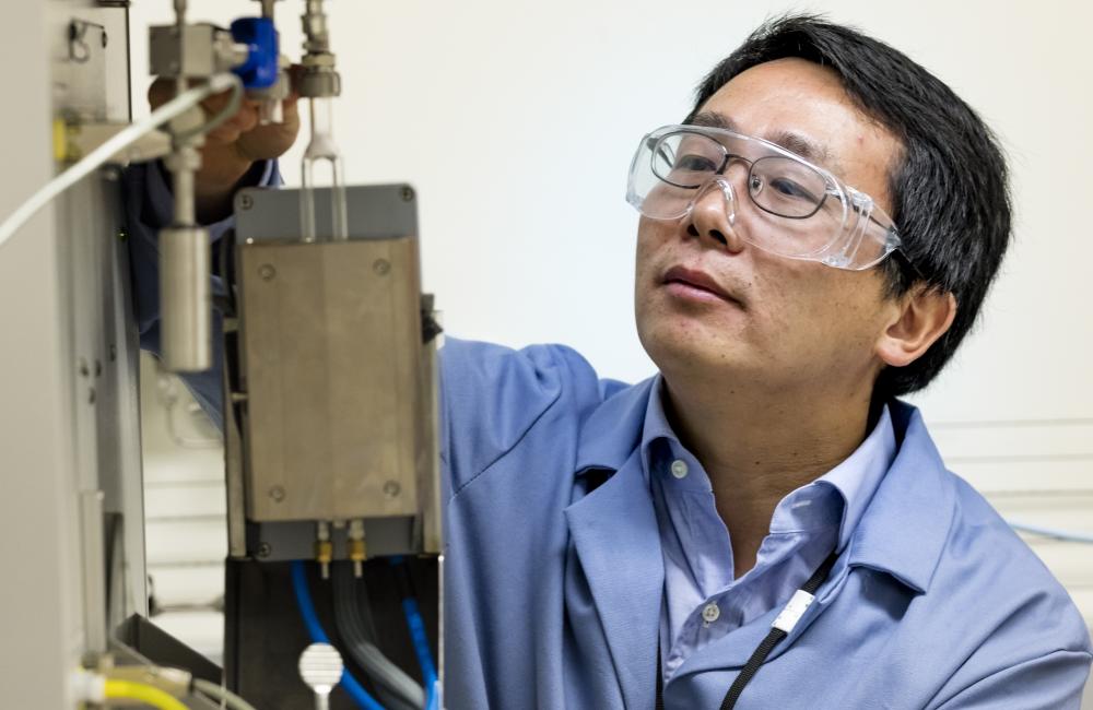 Chemist Zili Wu makes discoveries about catalysts using a suite of sophisticated tools, such as this adsorption microcalorimeter to probe catalytic sites. Image credit: Oak Ridge National Laboratory, U.S. Dept. of Energy; photographer Carlos Jones