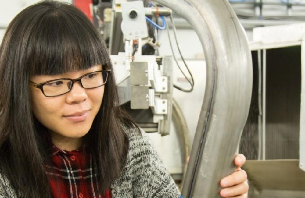 Lu Huang, USS industrial research engineer prepares a lightweighted advanced high strength steel component for neutron research at the Spallation Neutron Source’s VULCAN instrument. 