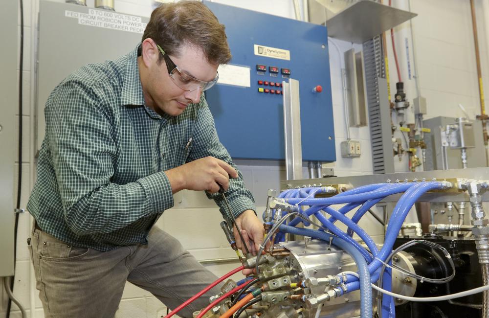 Oak Ridge National Laboratory researcher Tim Burress works with a prototype motor that generates 75 percent more power than comparable commercial motors without the use of rare earth materials.