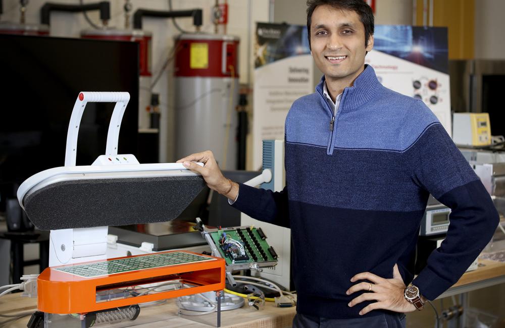 ORNL’s Viral Patel with his advanced ultrasonic clothes dryer.