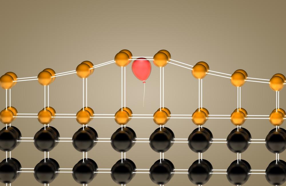 Inserting helium atoms (visualized as a red balloon) into a crystalline film (gold) allowed Oak Ridge National Laboratory researchers to control the material’s elongation in a single direction. 