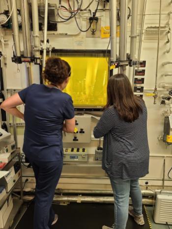 ORNL technicians Summer Widner, left, and Stephanie Timbs process thorium-228 in a hot cell. 