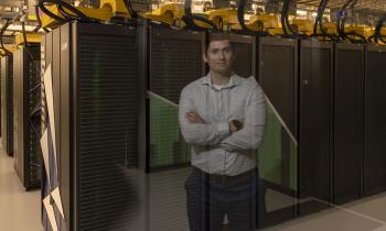 A man's reflection over the servers of Summit supercomputer